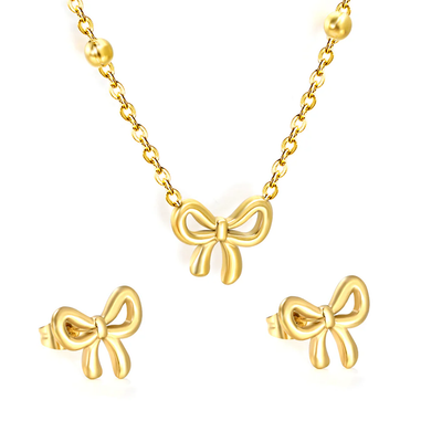 Tresoli Stainless Steel Gold Color PVD Bowtie With Cross Link Chain Earrings And Necklace Set